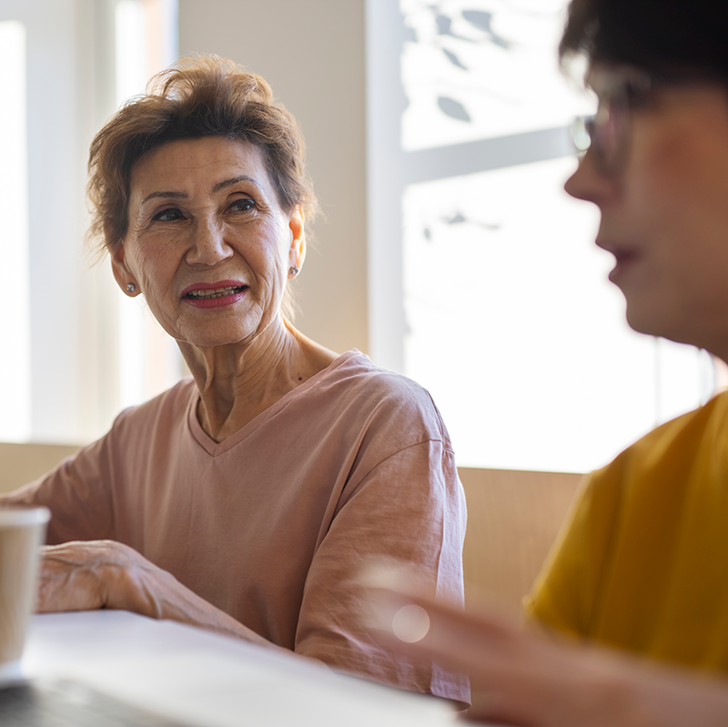 stock image of two senior women at support group meeting